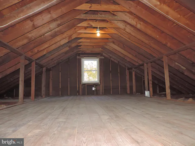 a view of backyard with a small cabin and wooden floor
