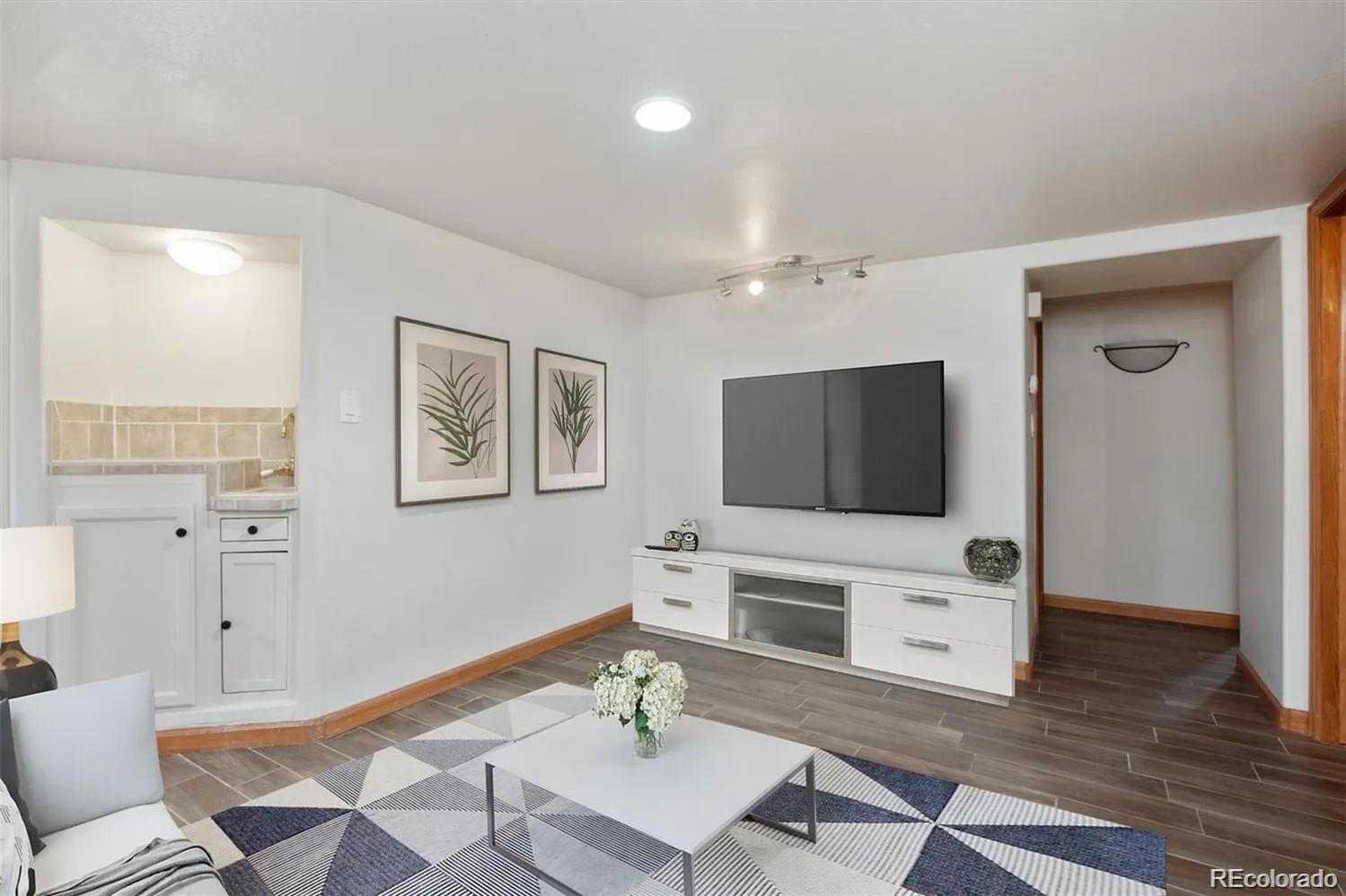 3201 Stuart Street Denver, CO 80212 - Photo 11 of 25 a living room with furniture and a flat screen tv