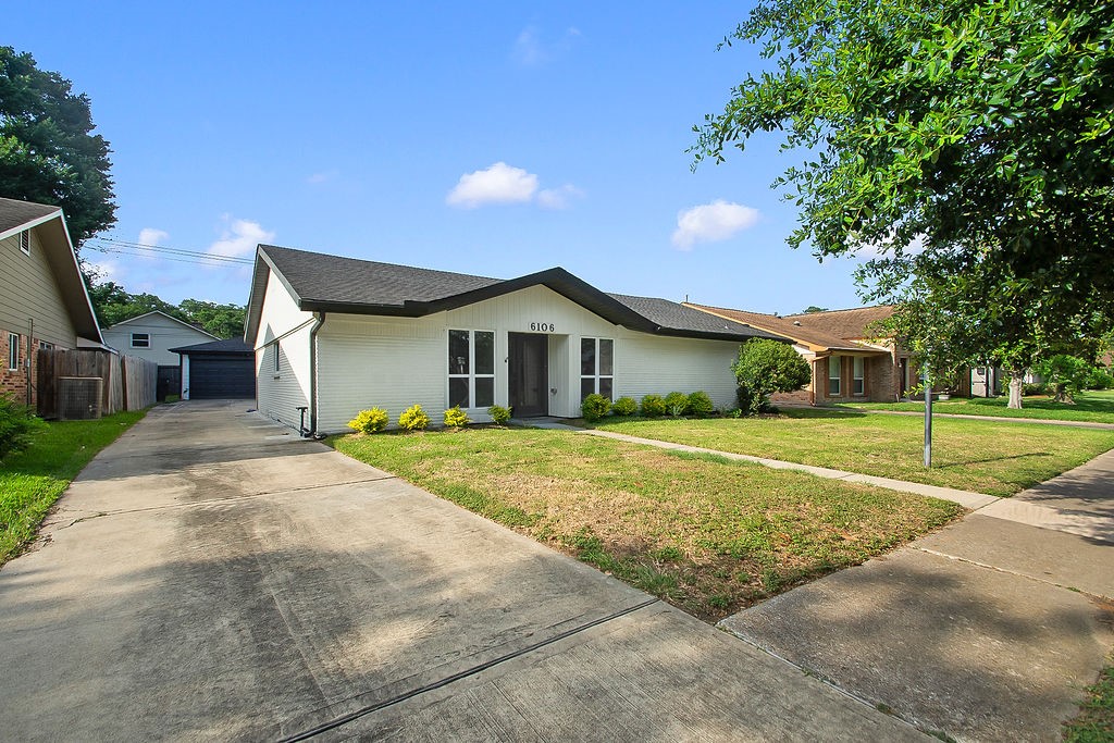 6106 Rutherglenn Drive Houston, TX 77096 - Photo 2 of 41 Front exterior view showcasing the spacious driveway, updated finishes, and expansive front yard.