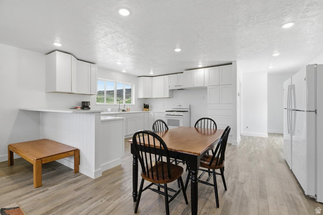916 North Bonneville Road Preston, ID 83263 - Photo 6 of 37 Dining room with a textured ceiling, light wood-style floors, and recessed lighting