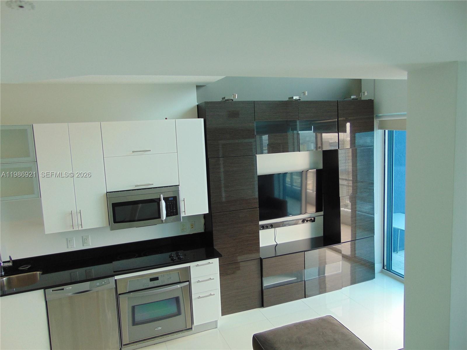 60 Southwest 13th Street, Unit 2619 Miami, FL 33130 - Photo 26 of 27 a kitchen with stainless steel appliances a cabinets and a counter top space