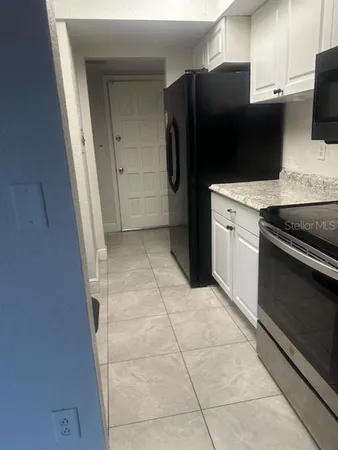 a kitchen with stainless steel appliances a refrigerator and a stove