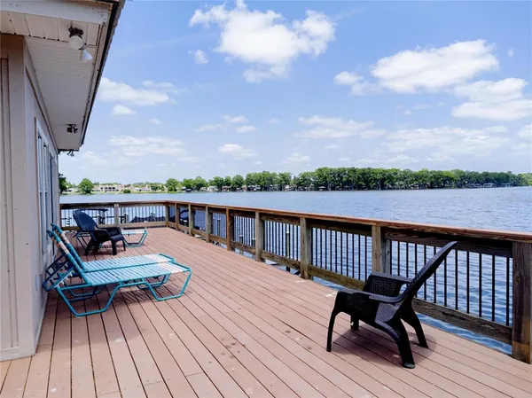 a view of balcony with wooden floor and seating space