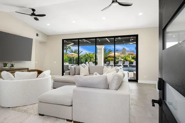 a living room with furniture and a large window