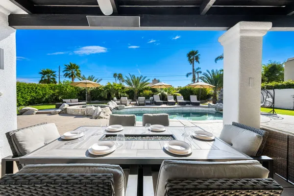 a view of swimming pool with outdoor seating and yard