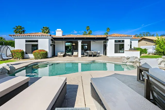 a spacious bathroom with a double vanity sink mirror and a bathtub