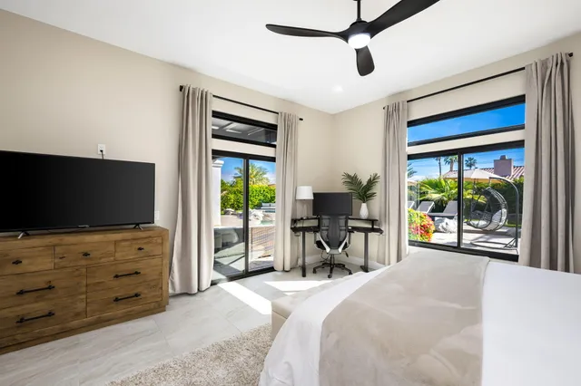 a bedroom with a bed and a flat screen tv