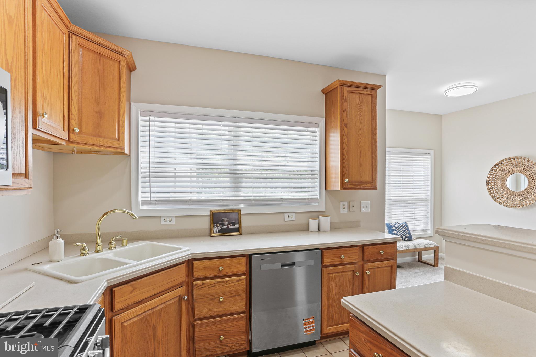 10232 Rutland Round Road, Unit 24 Columbia, MD 21044 - Photo 10 of 31 a kitchen with a sink stove and cabinets