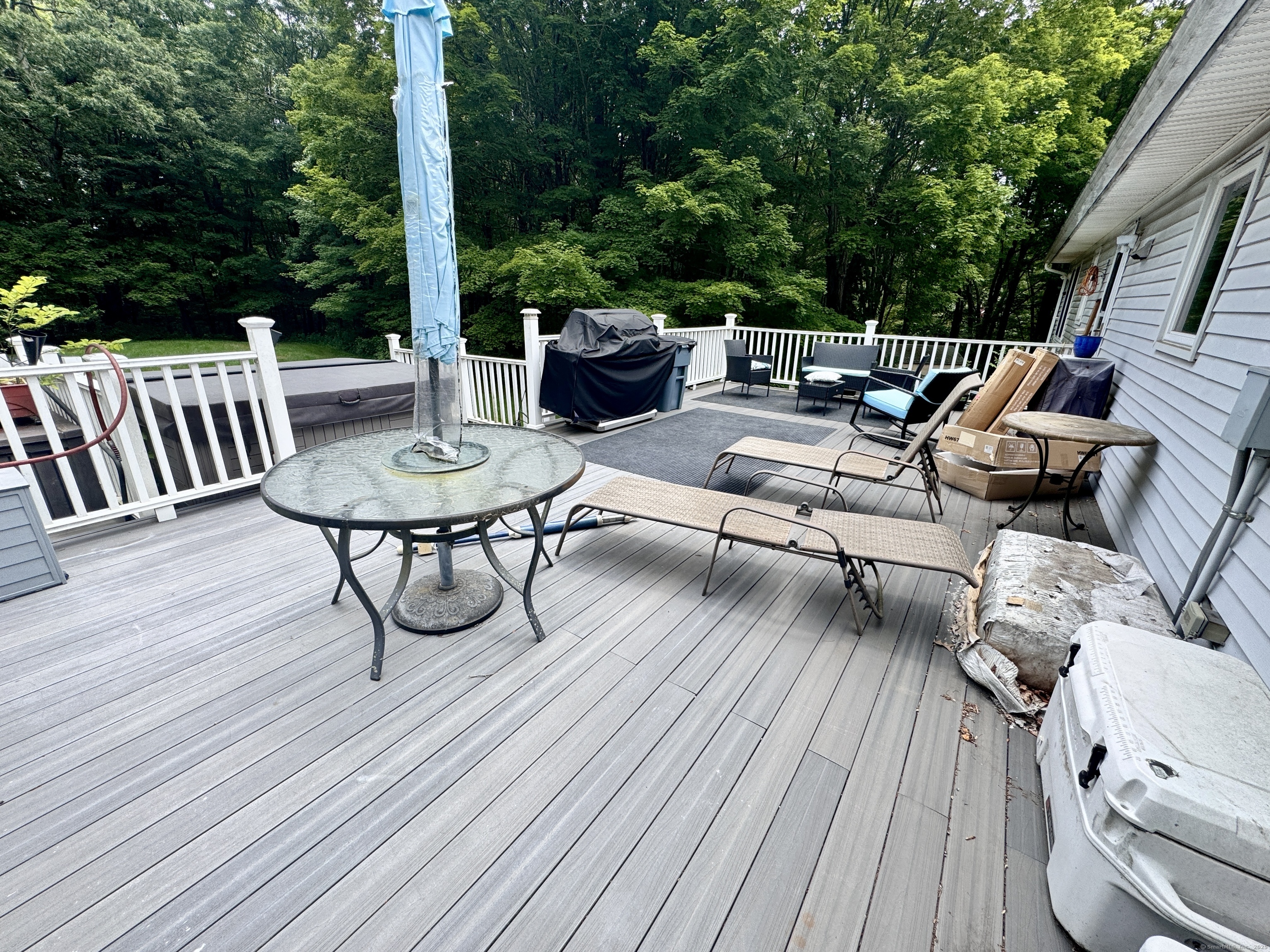 108 Webb Circle Monroe, CT 06468 - Photo 22 of 24 a view of a roof deck with table and chairs couches with wooden floor and fence