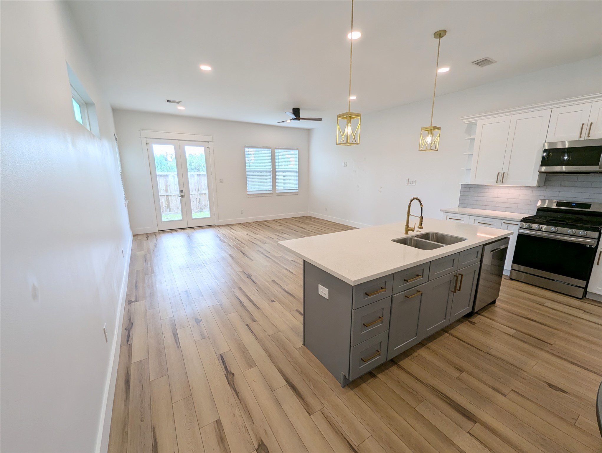 4913 Fisk Street Houston, TX 77009 - Photo 4 of 27 a kitchen with wooden cabinets and sink