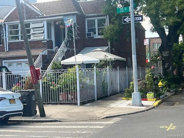 a view of a house with a yard and potted plants