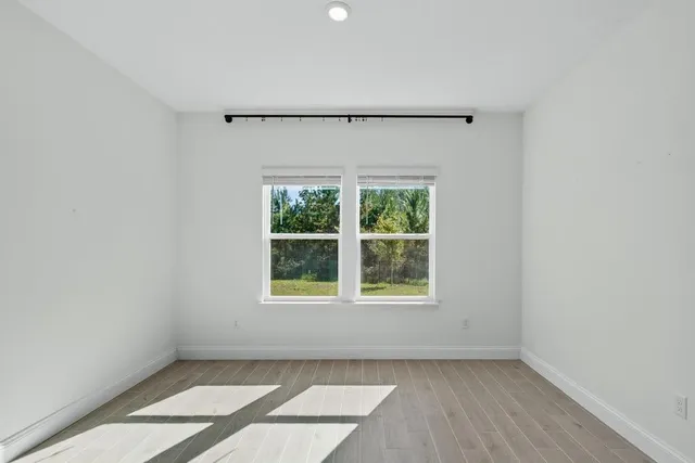 an empty room with a ceiling fan