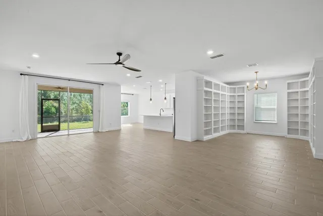 a kitchen with stainless steel appliances granite countertop a refrigerator a sink a stove a microwave and white cabinets