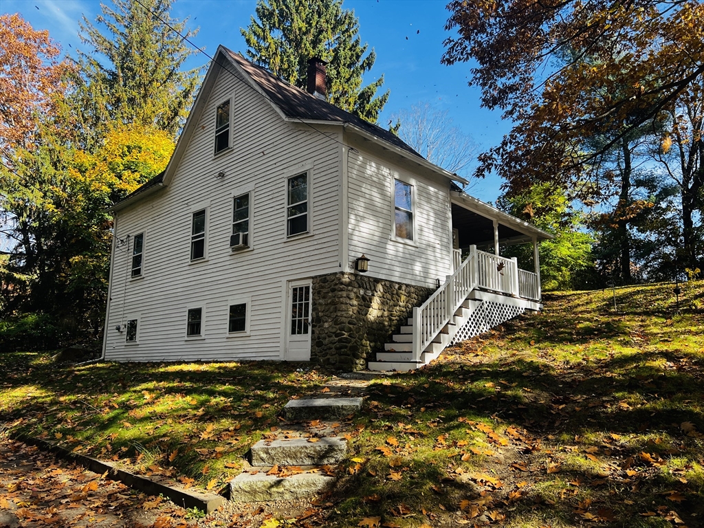 4 Hastings Road Spencer, MA 01562 - Photo 3 of 16 a view of a white house with a yard