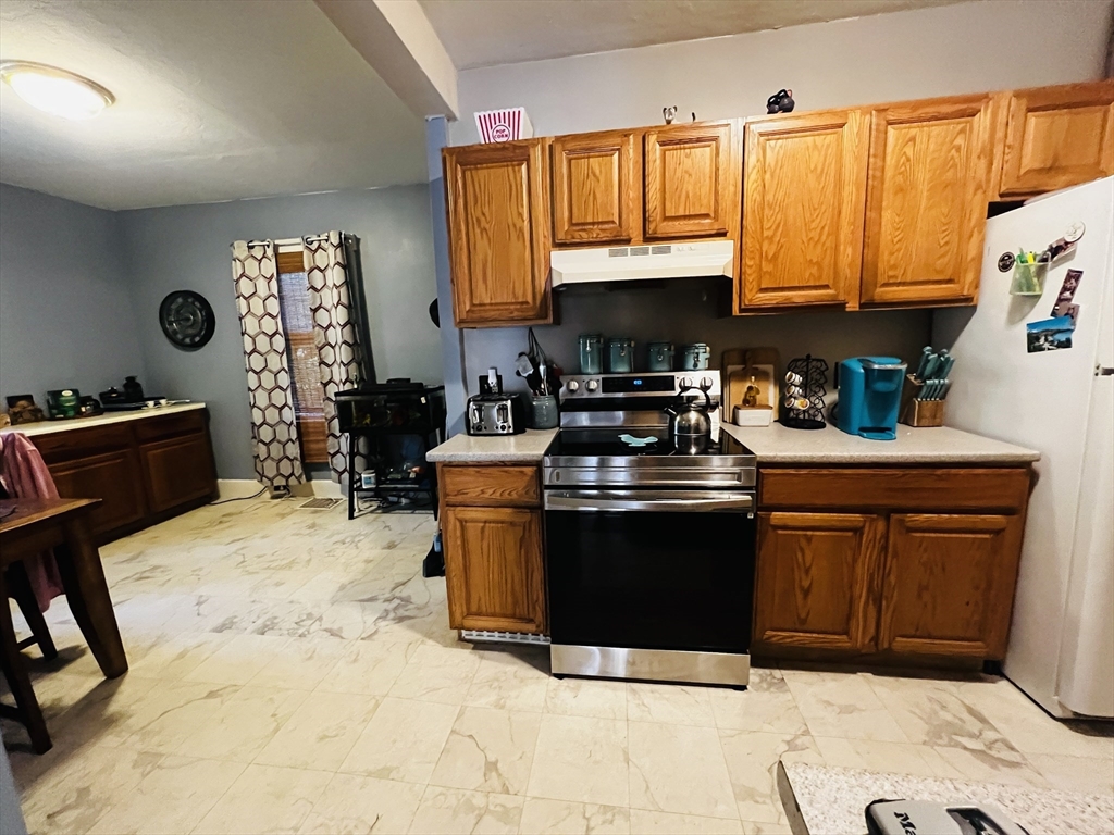 4 Hastings Road Spencer, MA 01562 - Photo 5 of 16 a kitchen with stainless steel appliances granite countertop a stove a sink dishwasher and a microwave