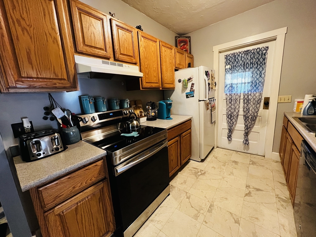 4 Hastings Road Spencer, MA 01562 - Photo 6 of 16 a kitchen with stainless steel appliances granite countertop a stove a sink and a cabinets