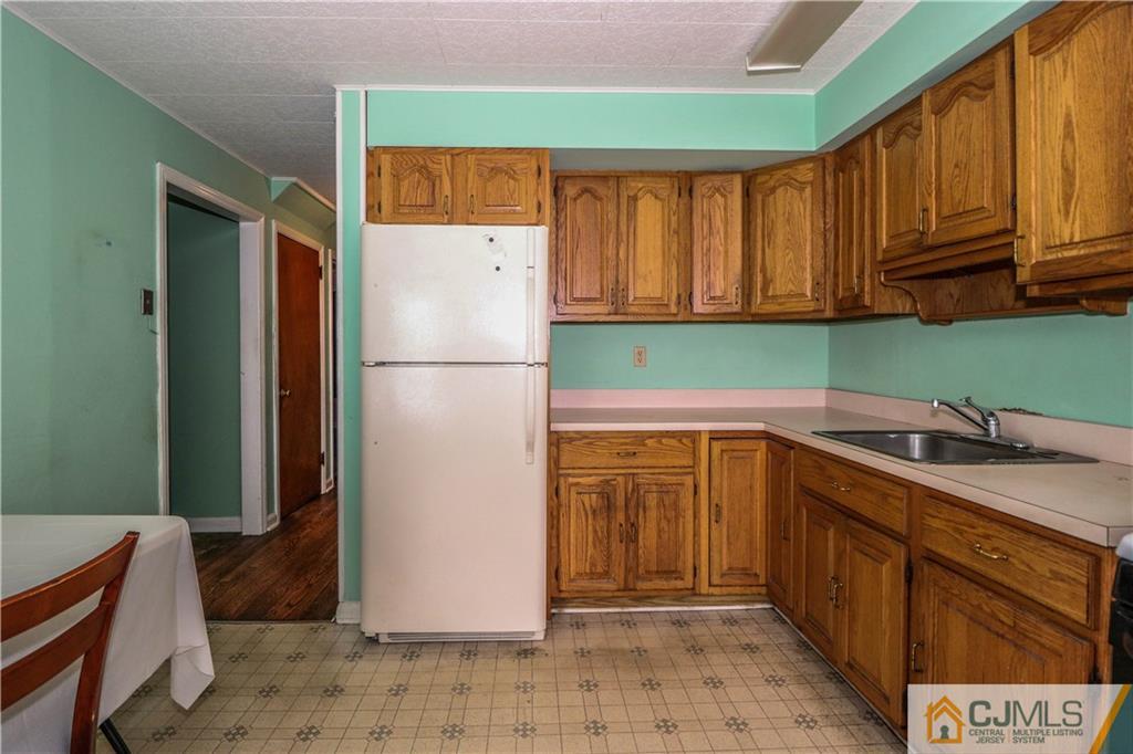 8 Kelly Street Metuchen, NJ 08840 - Photo 12 of 25 a kitchen with a refrigerator sink and cabinets