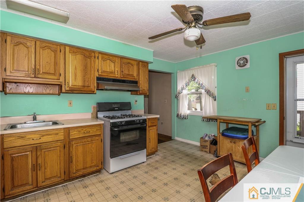 8 Kelly Street Metuchen, NJ 08840 - Photo 13 of 25 a kitchen with a stove a sink and a refrigerator