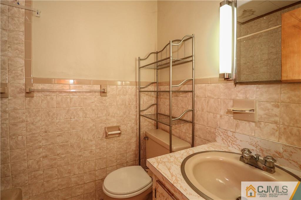 8 Kelly Street Metuchen, NJ 08840 - Photo 18 of 25 a bathroom with a sink a toilet and shower