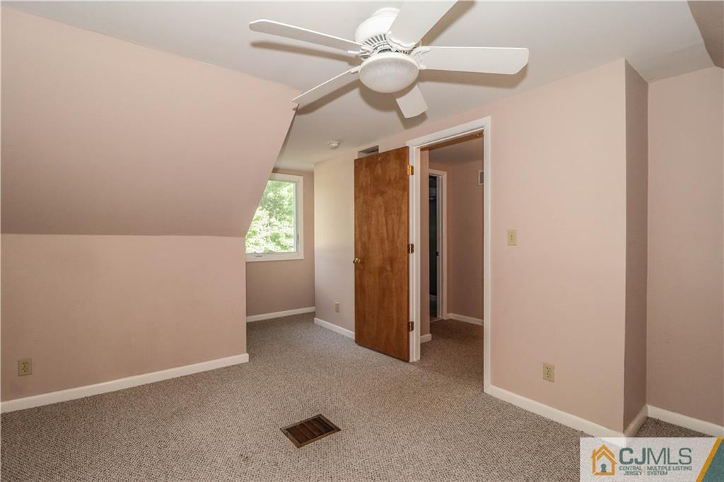 8 Kelly Street Metuchen, NJ 08840 - Photo 23 of 25 an empty room with ceiling fan and window