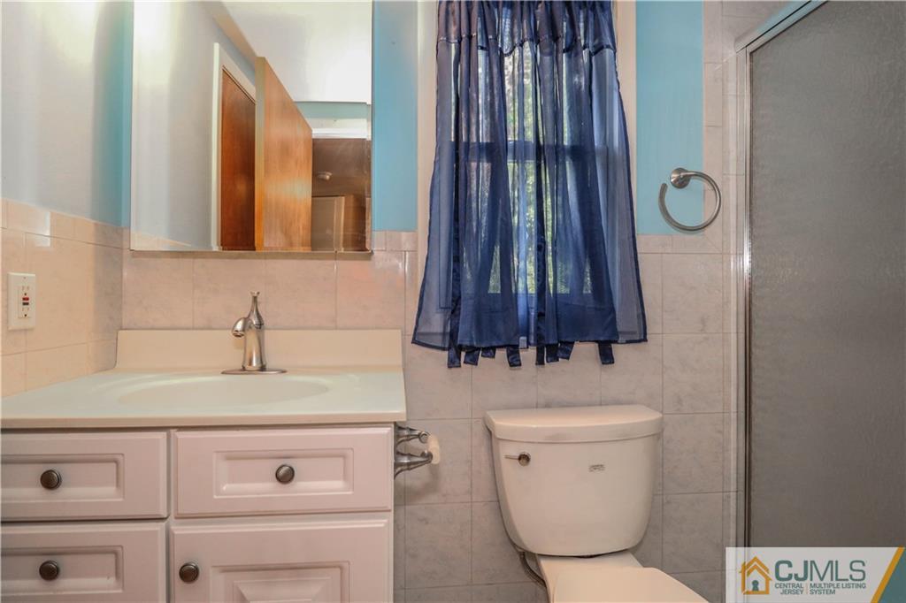 8 Kelly Street Metuchen, NJ 08840 - Photo 24 of 25 a bathroom with a toilet a sink and mirror