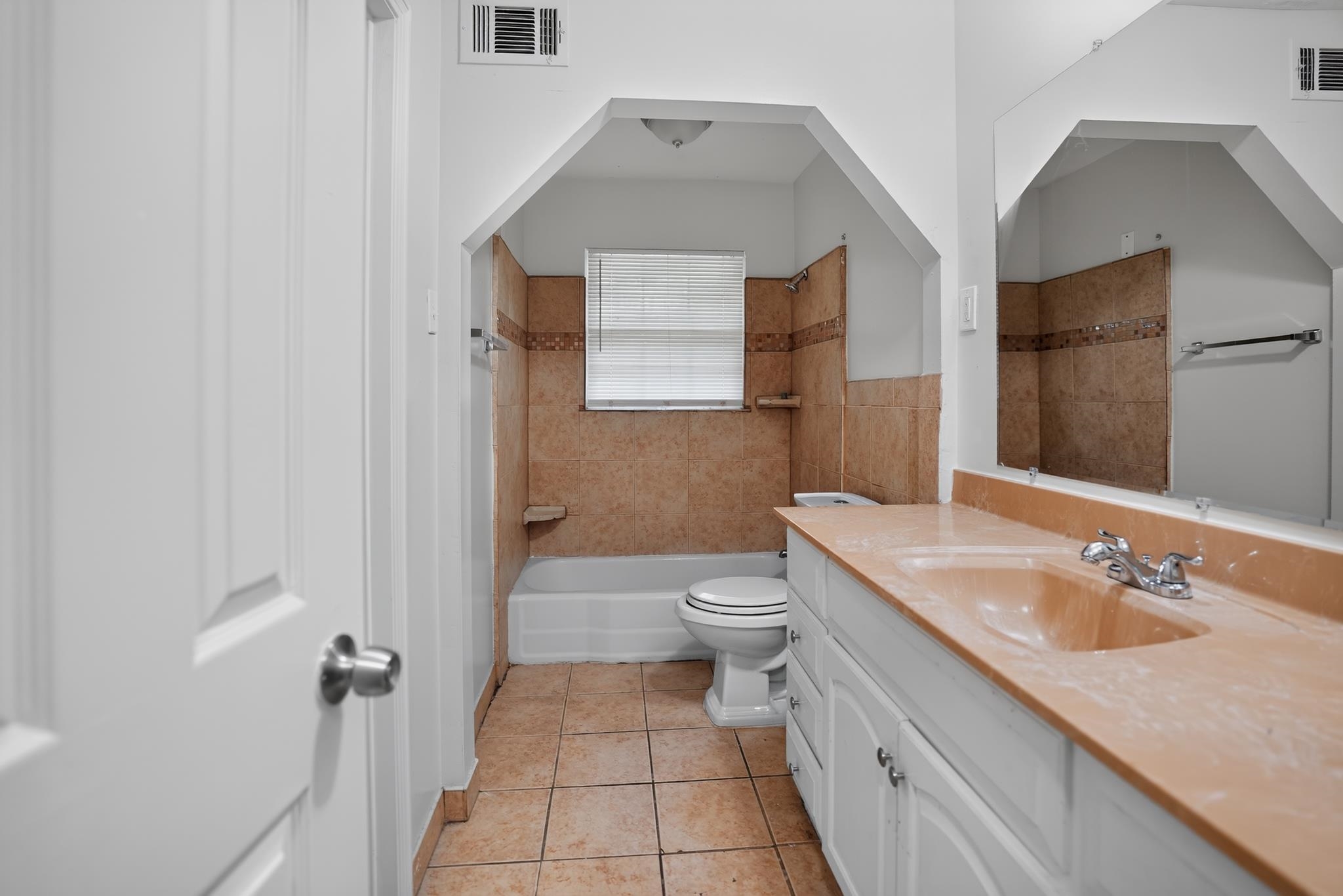 3391 South Perkins Road Memphis, TN 38118 - Photo 14 of 16 Bathroom featuring a vanity with an integrated sink and chrome faucet, a large wall-mounted mirror, and tile flooring