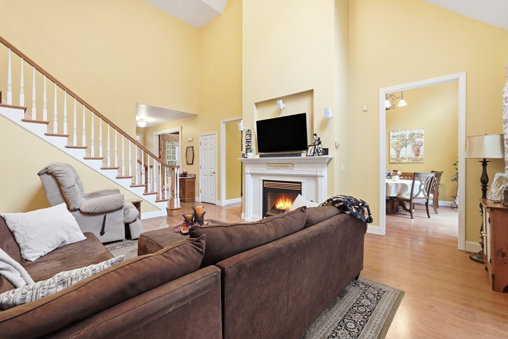 113 Greenwich Plains Road Ware, MA 01082 - Photo 13 of 42 a living room with furniture a flat screen tv and a fireplace