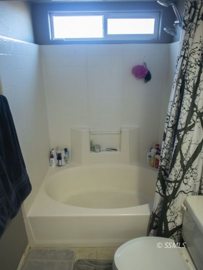 1411 Sims Street Ridgecrest, CA 93555 - Photo 27 of 35 a white bath tub sitting next to a white toilet