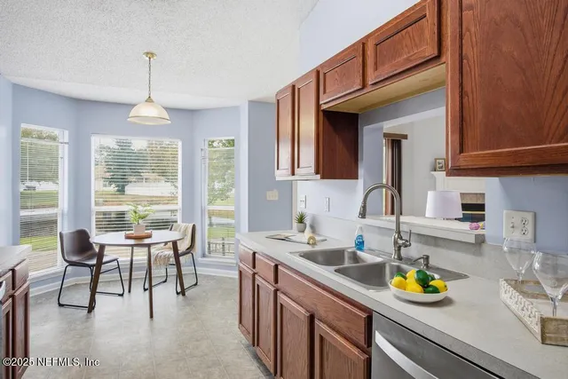 a kitchen with a sink a counter and chairs