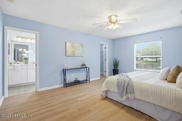 a bedroom with a large bed and a chandelier