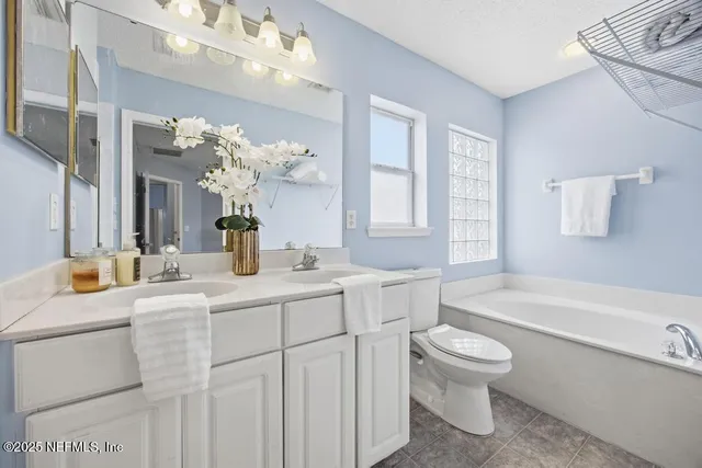 a bathroom with a sink a toilet and bathtub