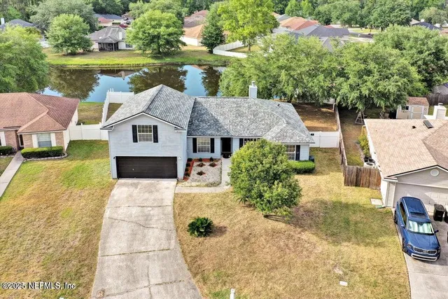 a aerial view of a house with a yard