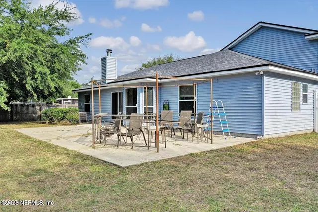 a view of a patio with table and chairs and potted plants