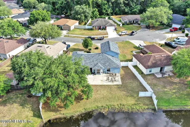 a view of swimming pool with outdoor seating and trees in the background
