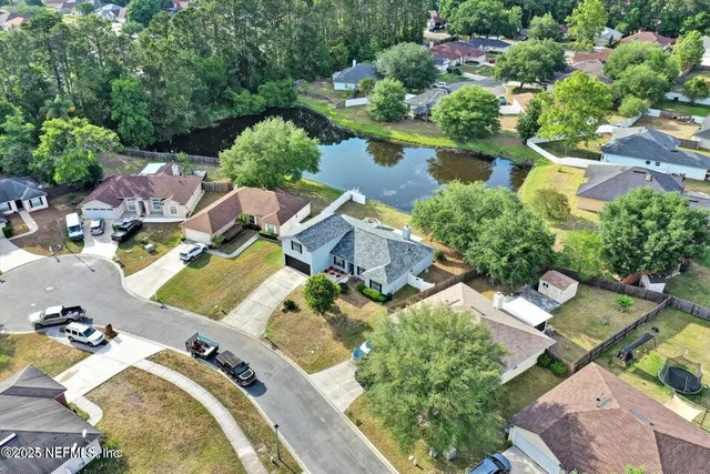 an aerial view of residential house with outdoor space and swimming pool