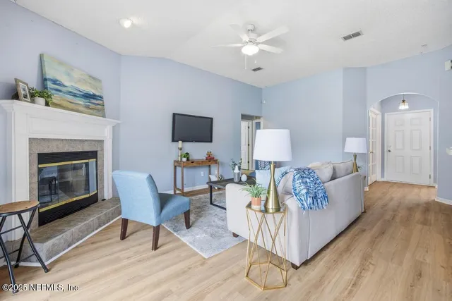 a living room with furniture and a fireplace