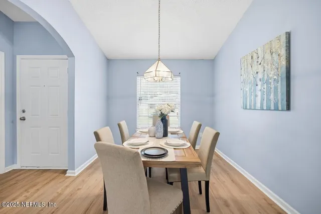 a dining room with furniture and window