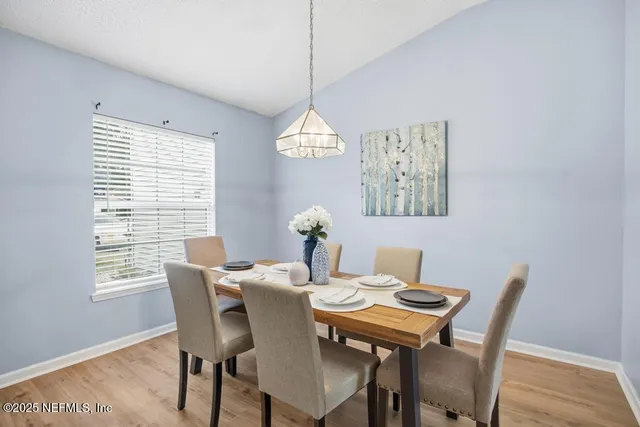 a dining room with furniture a rug and a window