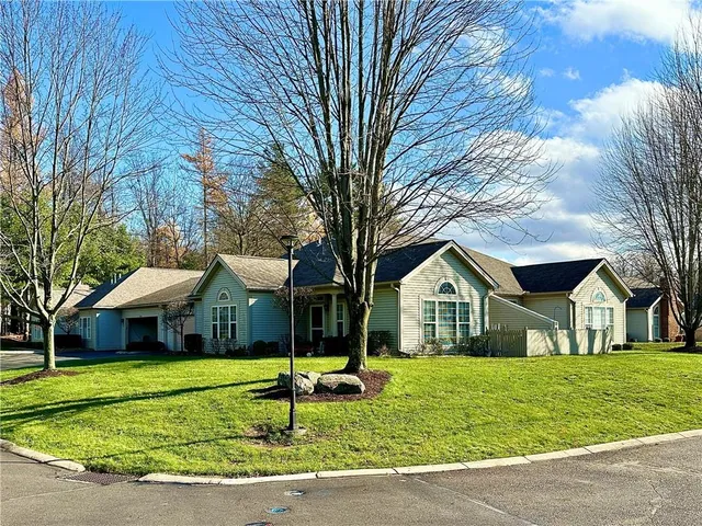 a front view of house with yard porch and green space