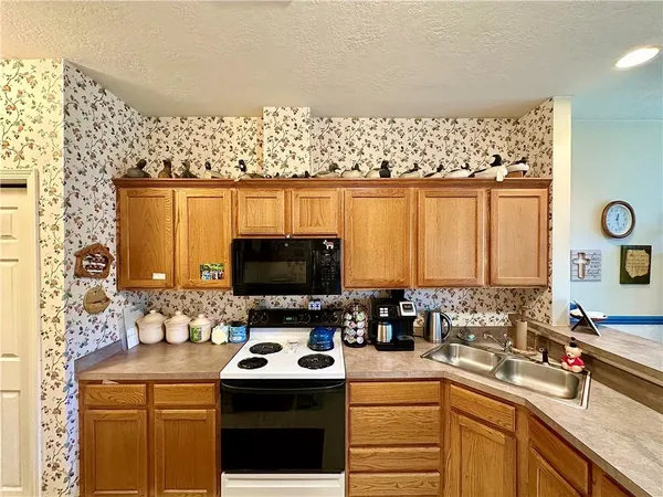 a kitchen with a sink a stove and a microwave