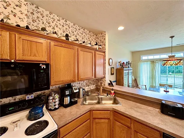 a kitchen with sink and large window