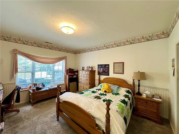 a bedroom with double bed and a large window
