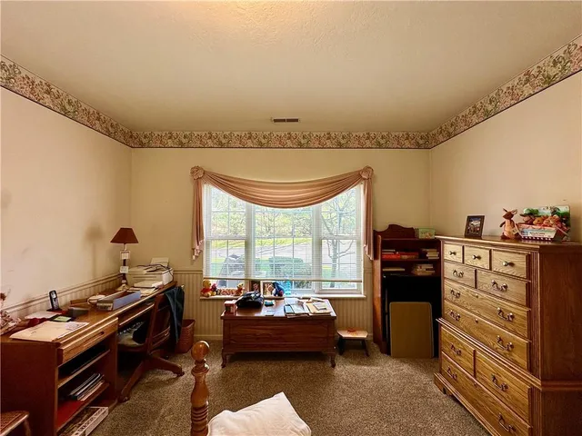 a bedroom with furniture and a window