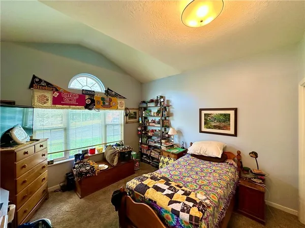 a bedroom with bed and a window