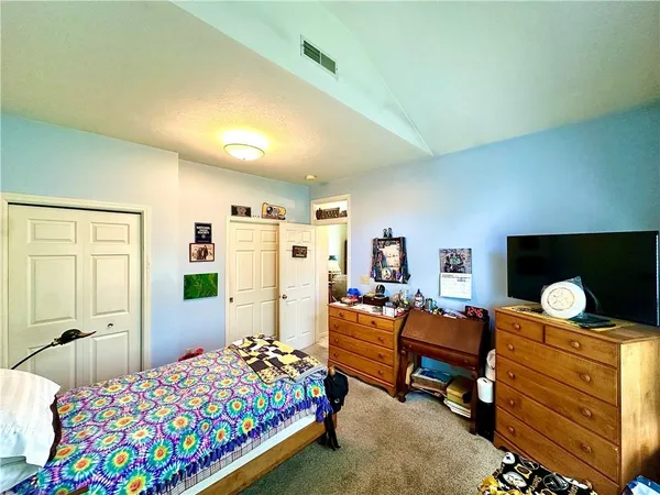 a bedroom with bed and a furniture