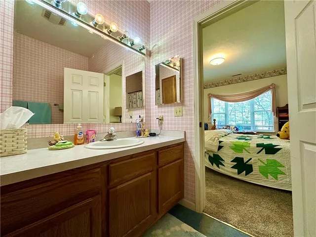 a bathroom with a double vanity sink and a large mirror