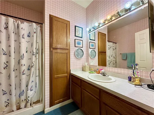 a bathroom with a double vanity sink and a mirror