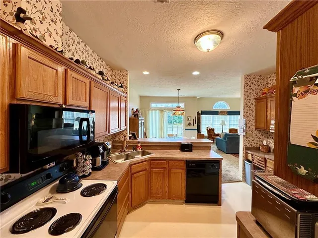 a kitchen with stainless steel appliances a sink stove and cabinets