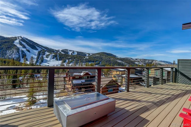 a view of a balcony with wooden floor and outdoor seating