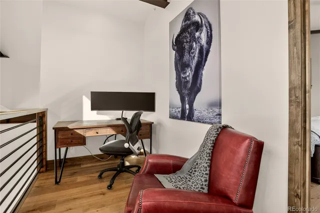 a view of a workspace with furniture and wooden floor